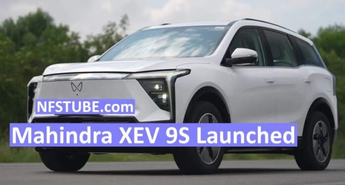 Mahindra XEV 9S electric SUV in white driving on road with NFSTUBE.com launch banner