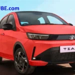 2026 Tata Tiago hatchback in red showcasing the updated front design, new styling elements, alloy wheels, and refreshed exterior launched in India.